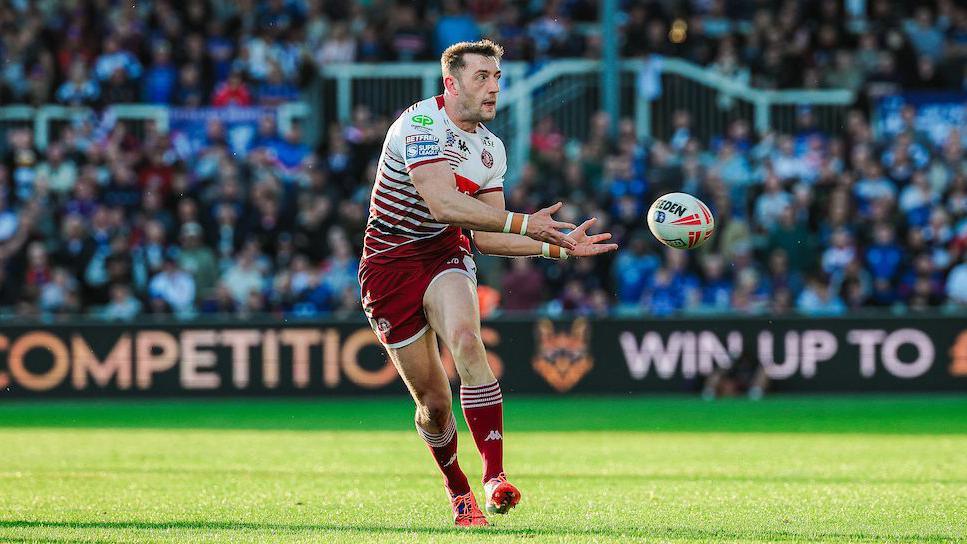 Jake Wardle of Wigan Warriors passing the ball.