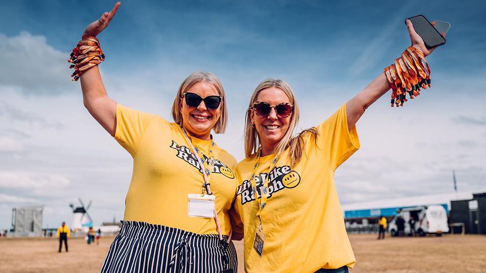 Two people in yellow t-shirts with the legend Live Like Ralph