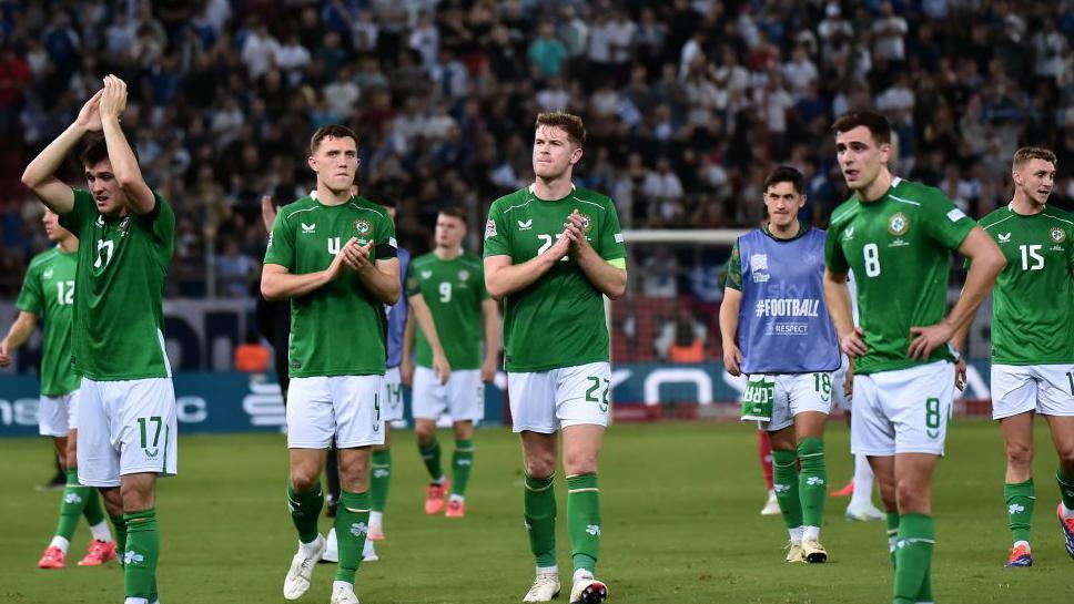 The Irish players applaud their fans at full-time