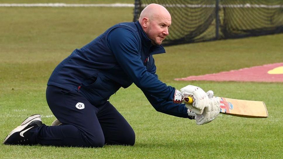 John Sadler giving catching practice