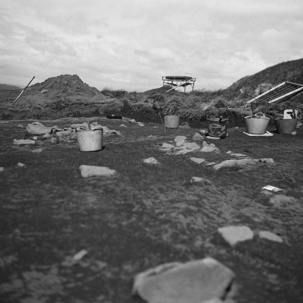 Buckets and rocks at the site of an archaeological excavation