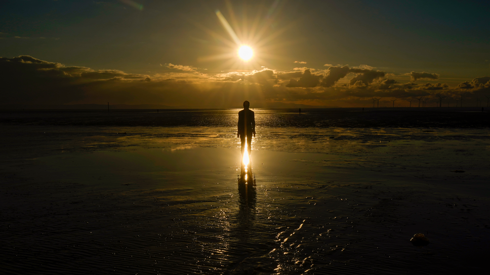 One of the statues against a sunset backdrop