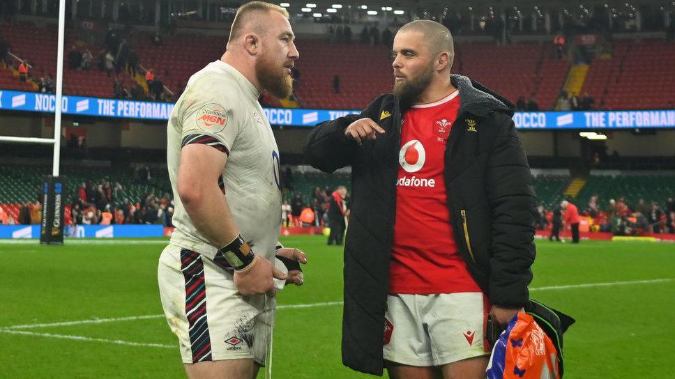 England prop Joe Heyes and Wales' Nicky Smith talk on the pitch at Principality Stadium