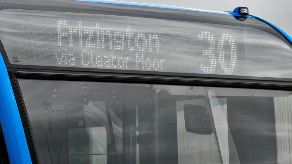 Close view of the front of a bus showing a 30 Frizington via Cleator Moor destination panel