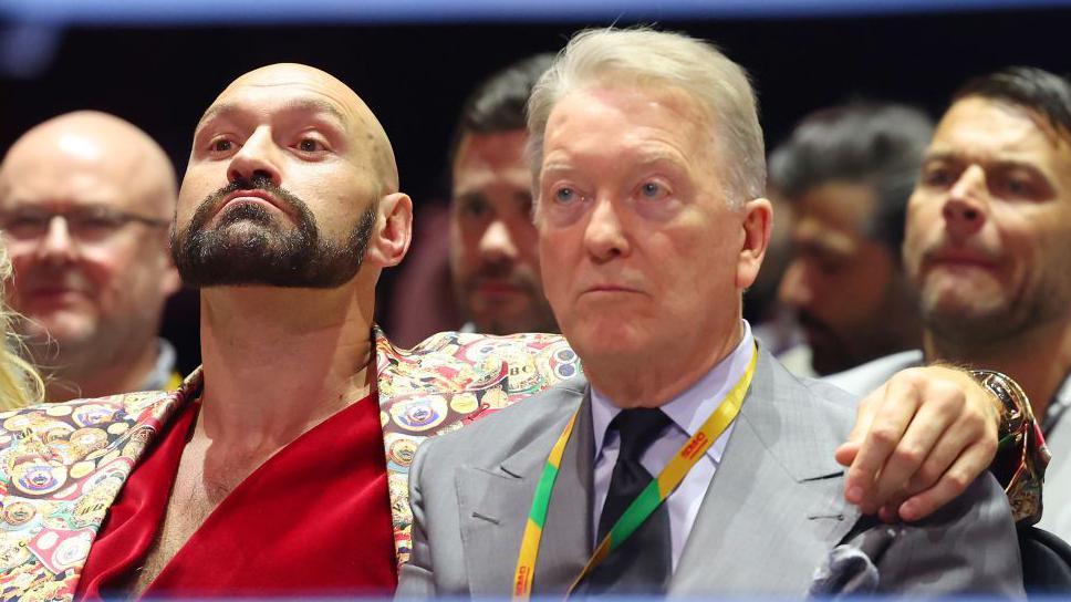 Tyson Fury has his arm around Frank Warren 