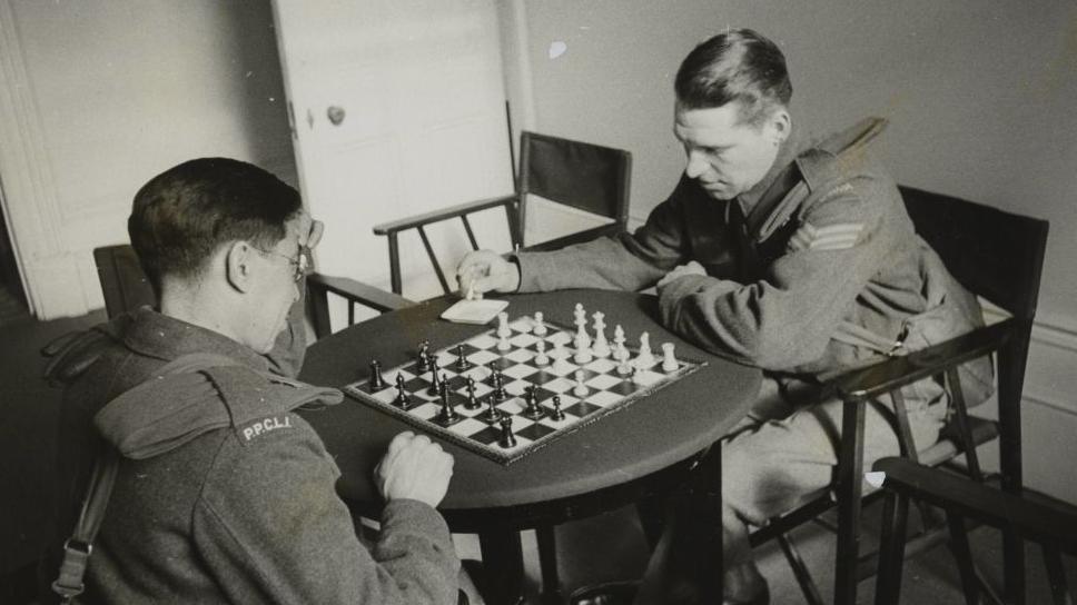 Two soldiers playing a game of chess at the Beaver Club