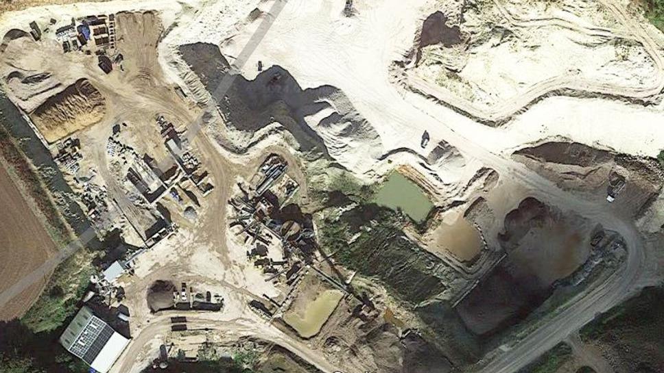 Aerial view of the quarry showing mounds of chalk, pathways and pools filled with water