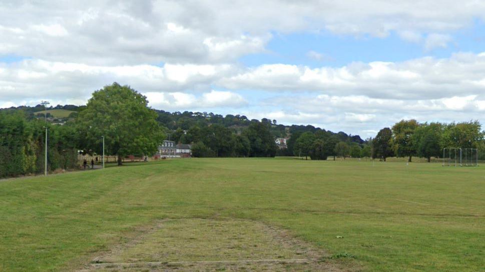 Google image of Exwick playing fields. There is a large green field surrounded by trees. 