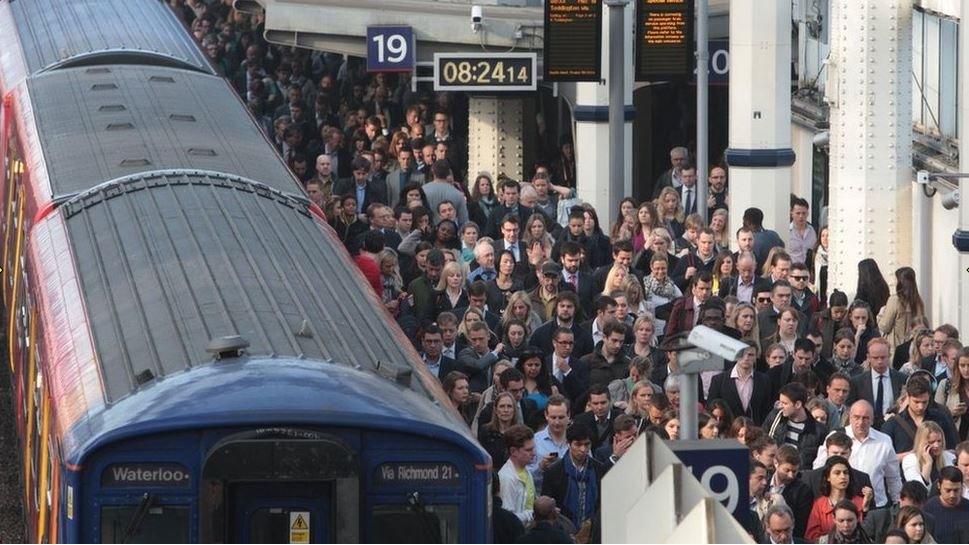 File photo of commuters waiting to pass through the barriers at Waterloo station during the tube strike