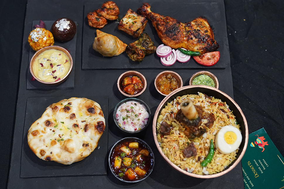 Numerous cakes created to look like different items from an Indian restaurant meal, including fake naan bread, chutneys and chicken and lamb dishes