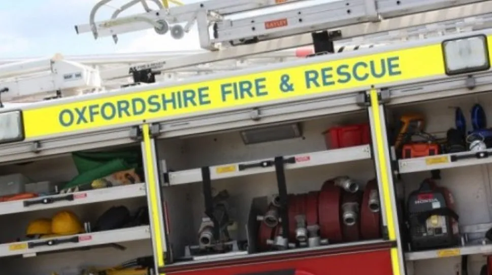 A fire engine opened up with equipment, like hoses and torches, on display 