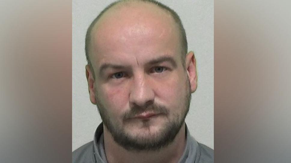 Mugshot of Paul Stoddart. He has a very short, dark beard and a shaved head.