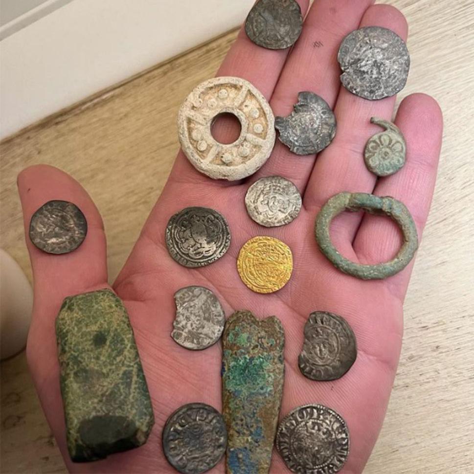 Assorted coins on palm of hand