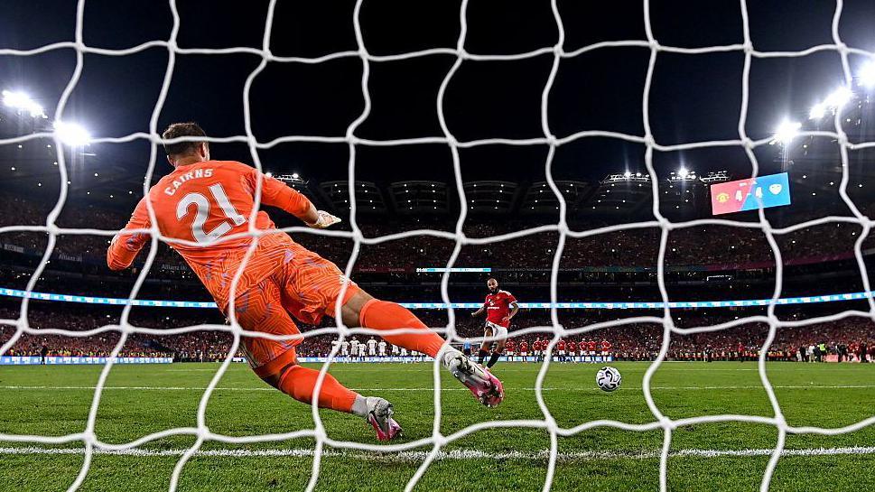 Noussair Mazraoui scores the winning penalty for Man Utd against Leeds