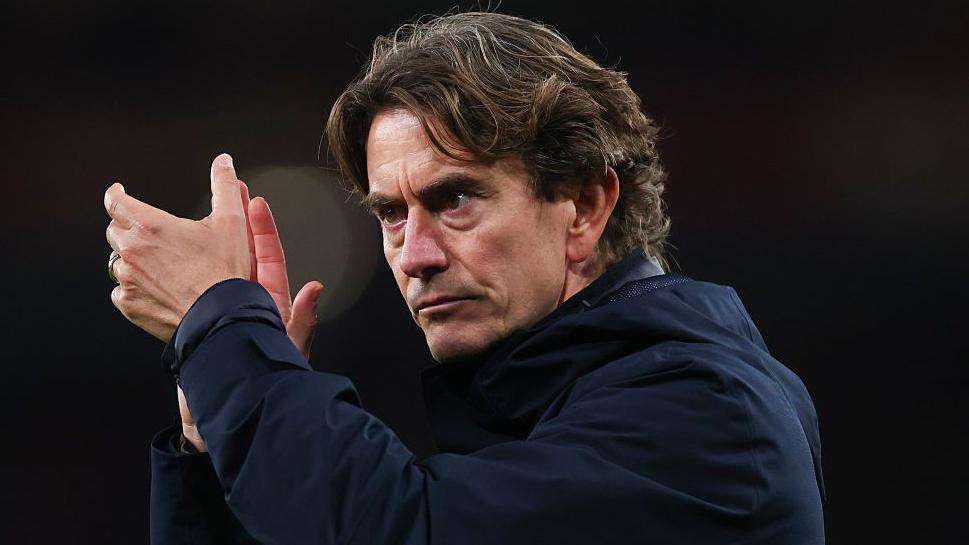 A glum Thomas Frank applauds the travelling fans following Tottenham's north London derby defeat at Arsenal