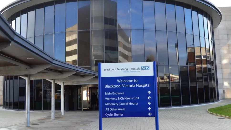 The exterior of Blackpool Victoria Hospital. It is a circular building covered with windows.