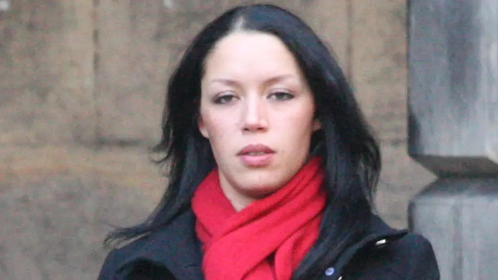 Denise Clair, pictured during the civil court case in 2017. She has shoulder-length black hair and is wearing a black coat and red scarf