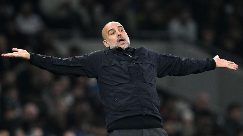 Pep Guardiola with his arms held out in a questioning gesture