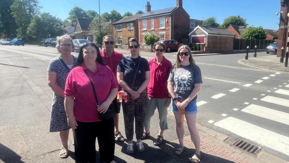 Group of parents - standing next to a zebra crossing outside the Werrington Primary School.
