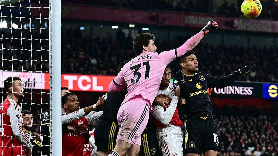 Manchester United goalkeeper Senne Lammens goes to punch the ball out of his penalty area during the 3-2 win against Arsenal at the Emirates Stadium