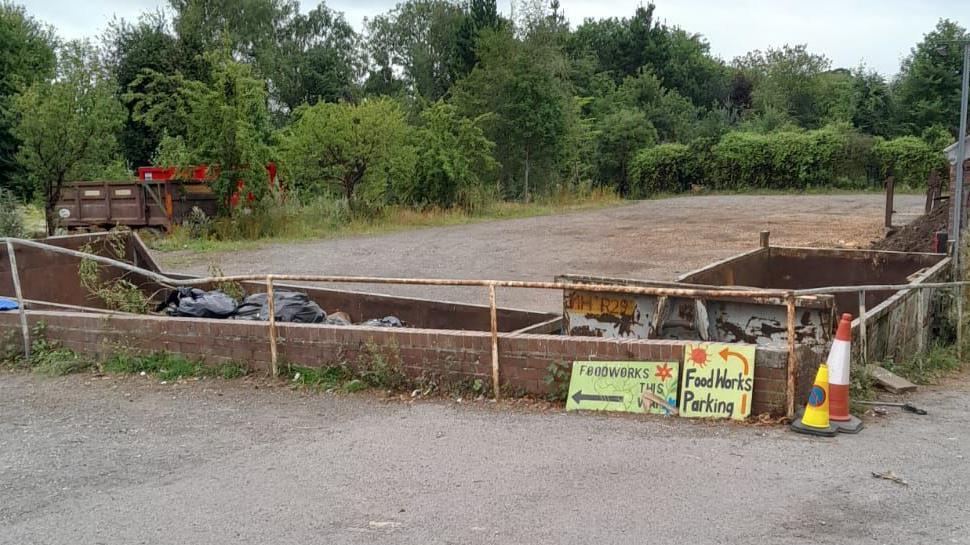 The image shows several containers on a site used for storing waste.