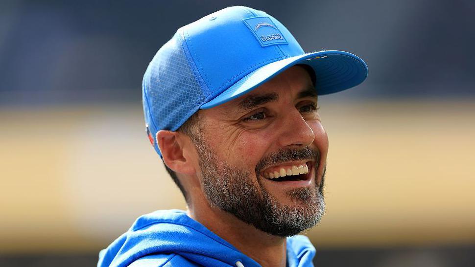 Jesse Minter, while serving as Los Angeles Chargers defensive co-ordinator, smiles before a game against the Indianapolis Colts