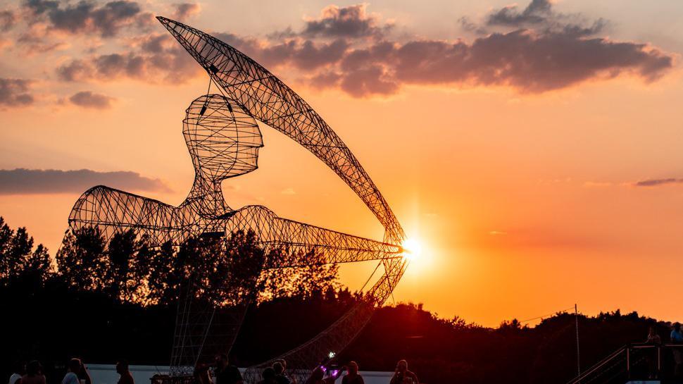 Archer sculpture set against the setting sun at Isle of Wight Festival