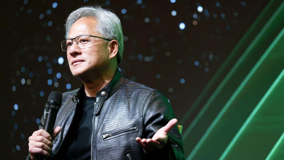 Nvidia CEO Jensen Huang holds a microphone as he speaks during a tech conference in Taiwan
