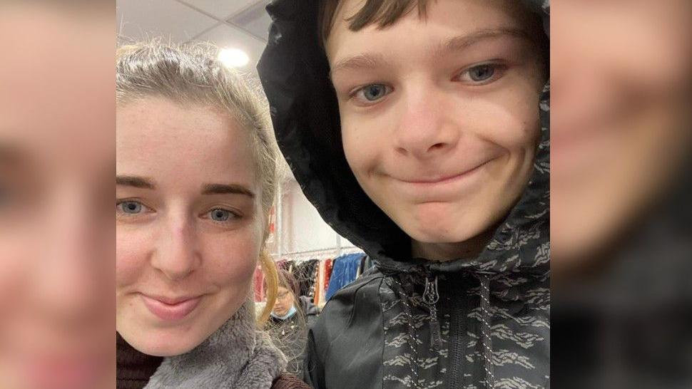 Chloe Rist and her brother Mason. Chloe has blonde hair and dark eyebrows - Mason has brown hair and is wearing a dark hoodie. 