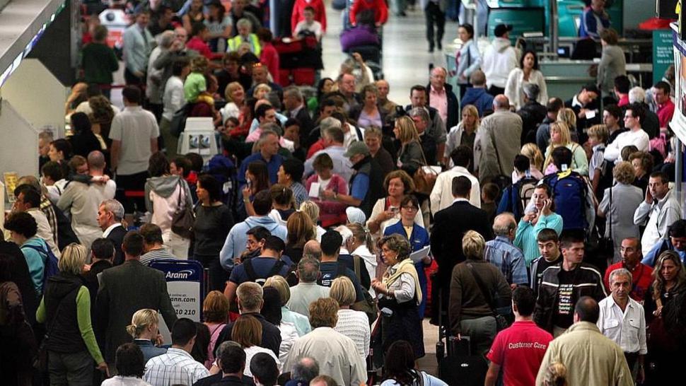 Long lines of people waiting to check in at Dublin airport

