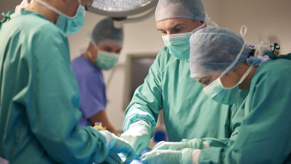 Surgeons operating on a patient