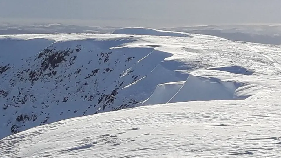 Looking south along the Helvellyn plateau, the summit is covered in thick snow