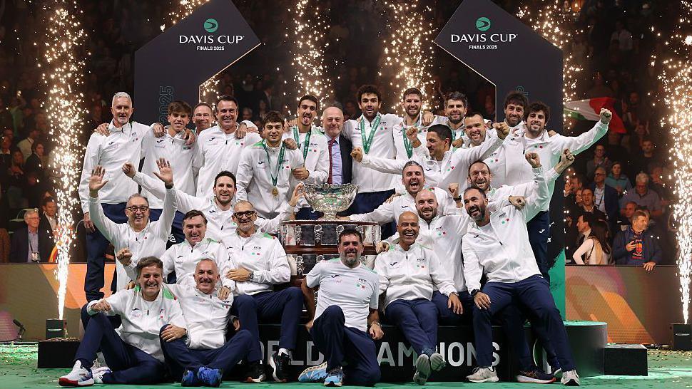The Italian team celebrate with the Davis Cup trophy
