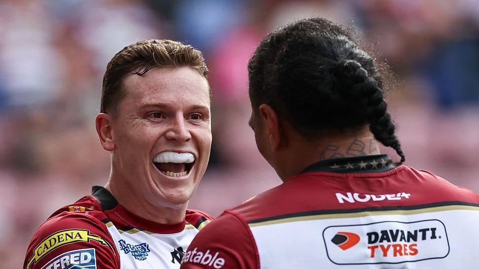 Wigan Warriors' Jai Field celebrates with Patrick Mago after scoring a try.