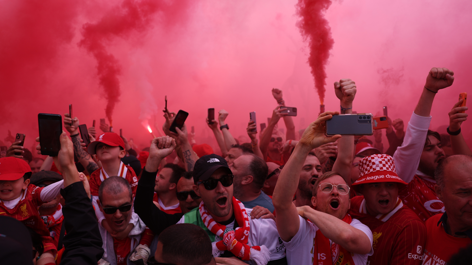 Liverpool fans amid red flare mist