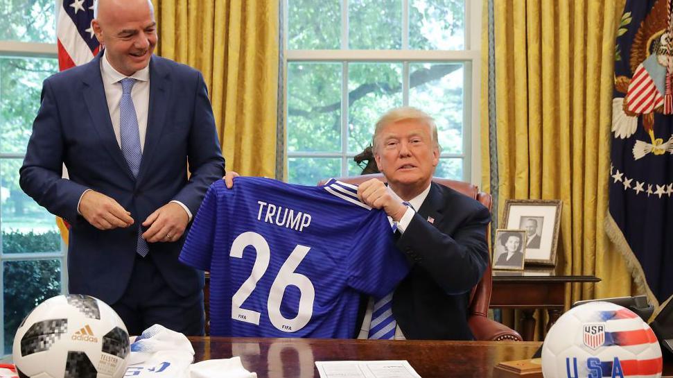 Donald Trump and Gianni Infantino pose with footballs and a shirt