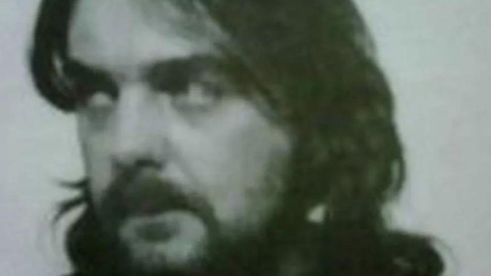 Andrew Barlow with long hair and beard