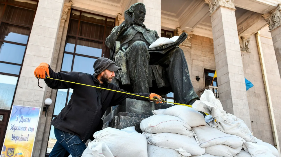 A museum worker takes measures to protect a statue in Zaporizhzhia