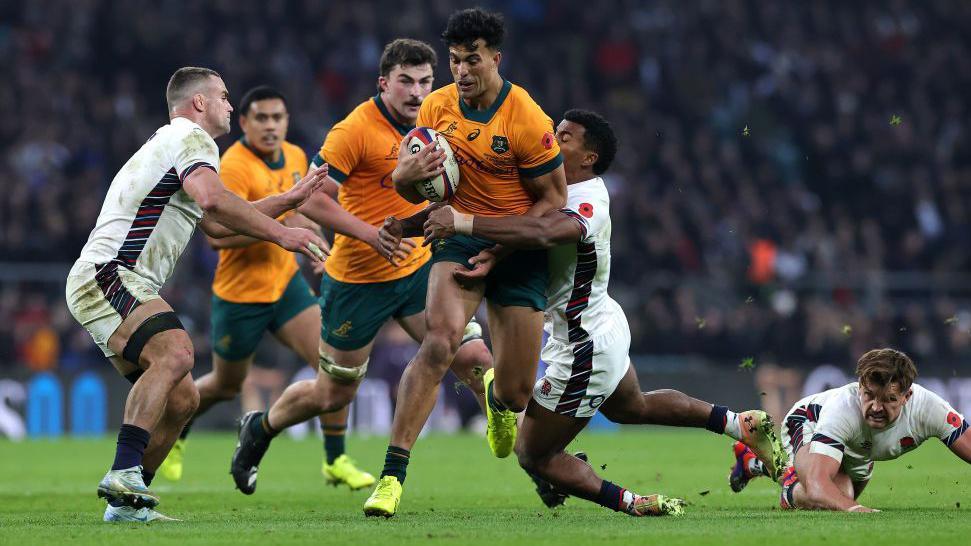 Joseph Suaalii breaks through the England defence during Australia's win at Twickenham in November