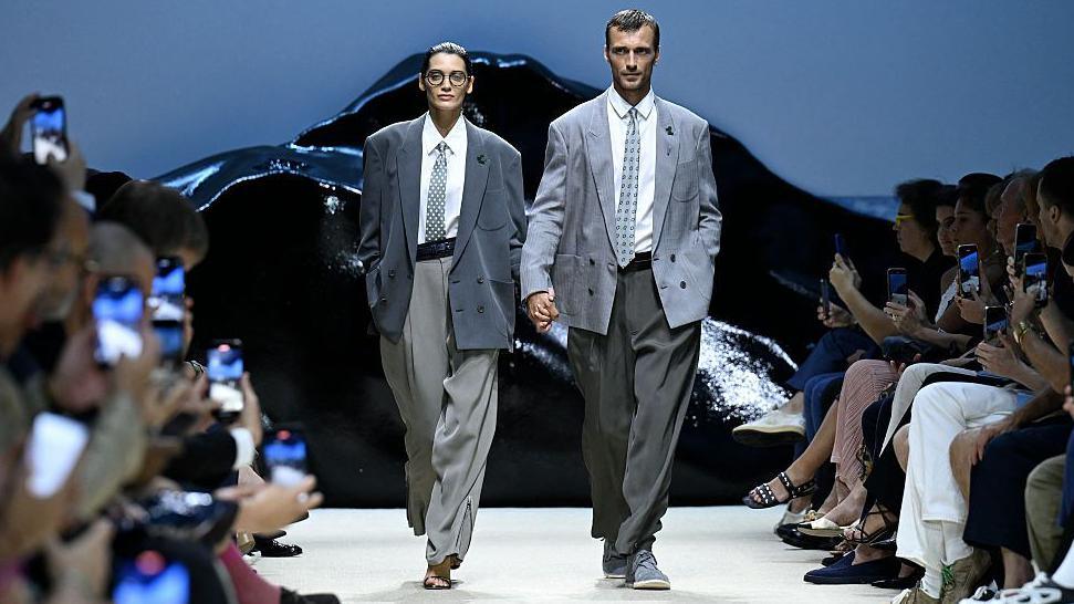 Man and woman in Armani suits