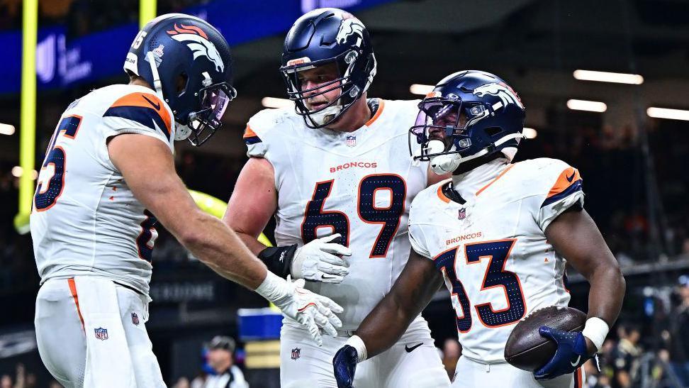 Javonte Williams (right) celebrates scoring a touchdown for the Broncos against the Saints