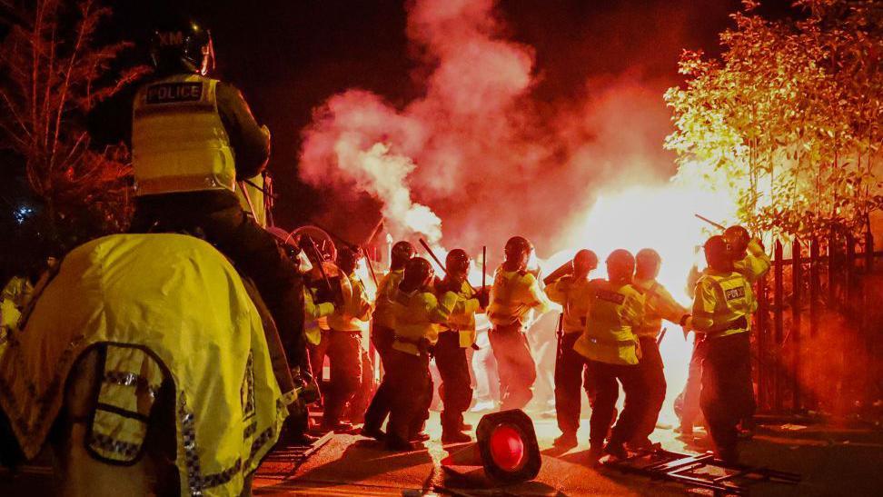 Police officers clash with Legia Warsaw fans outside the ground before the UEFA Conference League match against Aston Villa at Villa Park .