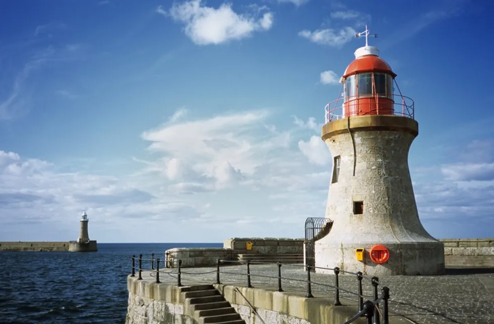 South Shields Pier has a small light house at the end of it over looking the ocean.