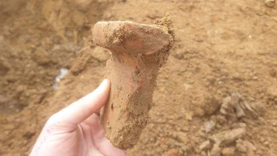 An Archaeologist holding one the findings 