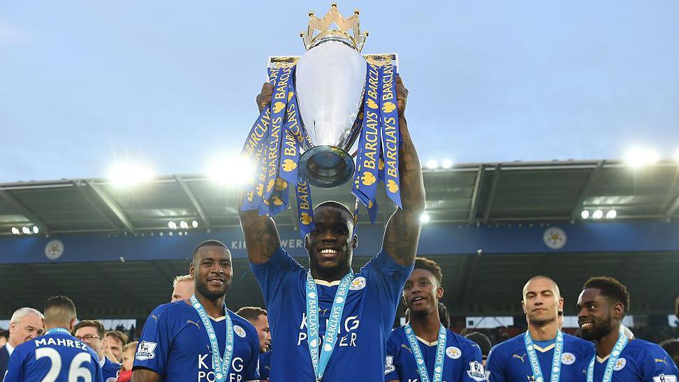 Jeffrey Schlupp lifting the Premier League trophy at Leicester City