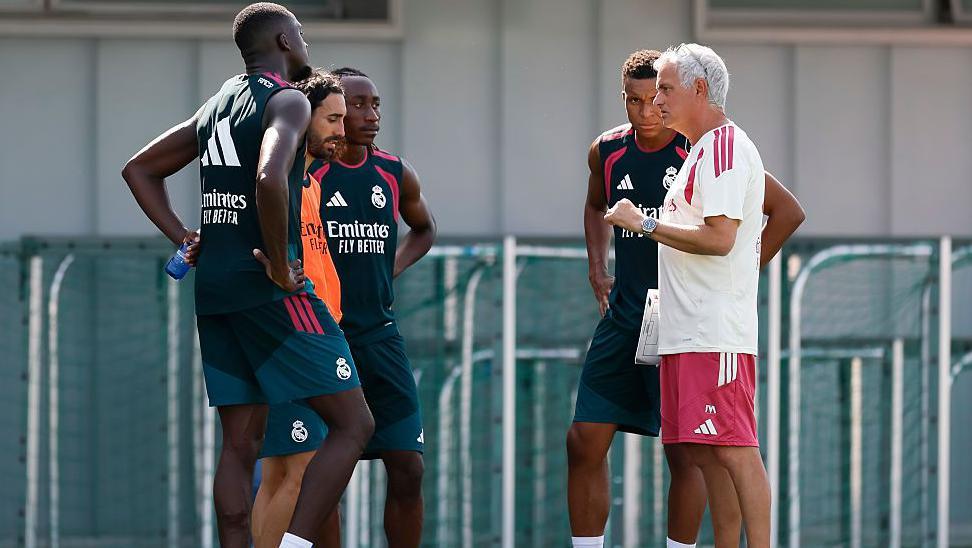 Jose Mourinho in conversation with players, including Marc Cucurella, Yan Diomande and Kylian Mbappe, at Real Madrid training