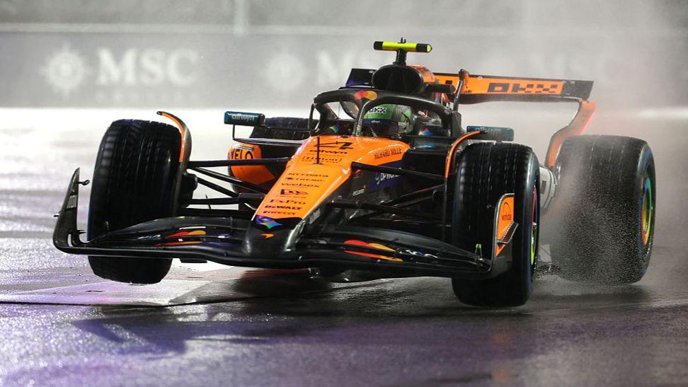 McLaren's Lando Norris with his front right tyre in the air during wet conditions in Las Vegas Grand Prix qualifying