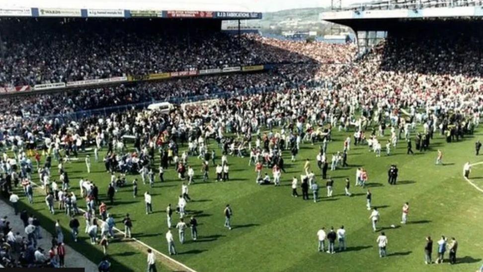 Hillsborough football stadium with a large crowd of fans on the pitch as the disaster unfolded