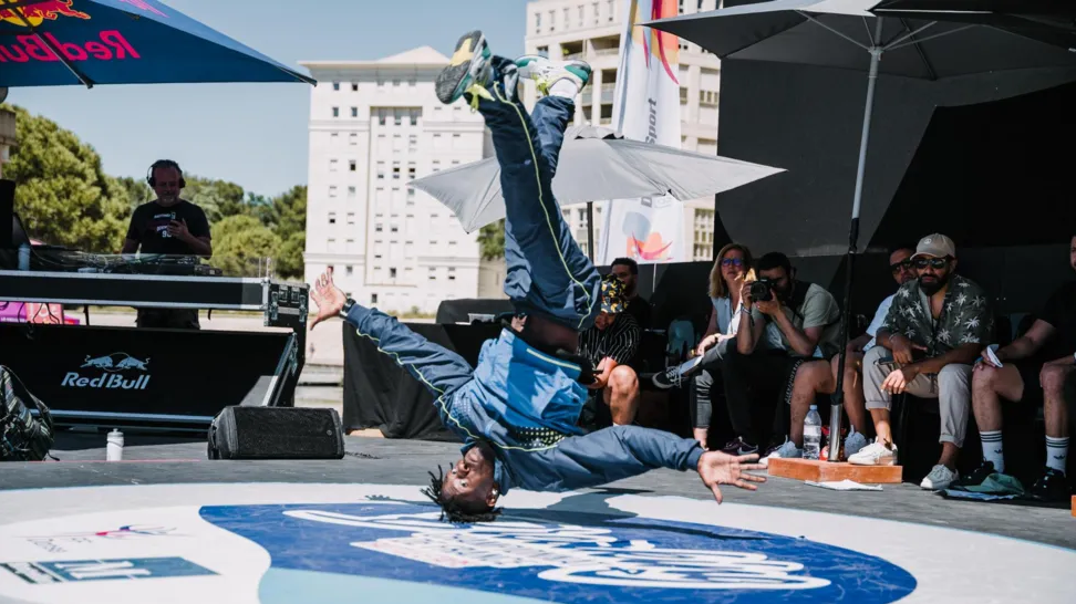 A breakdancer performances in front of a crowd