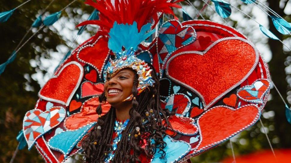 A woman in costume at Leeds West Indian Carnival